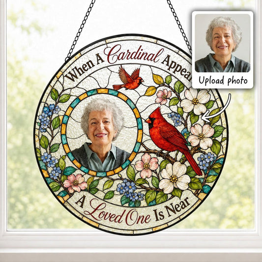 Round faux stained-glass suncatcher with two red cardinals, dogwood flowers, and a left-side circular photo frame.