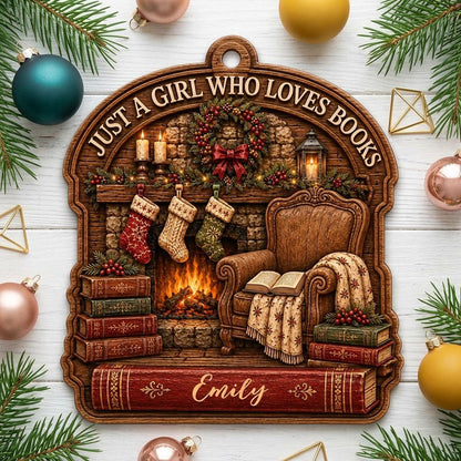 Wood ornament with fireplace, wreath, stockings, armchair and books, plus 'Just a Girl Who Loves Books' and a name.