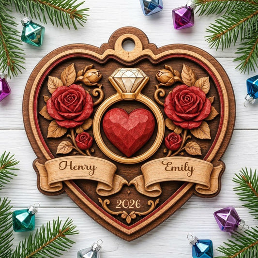 Heart-shaped wood ornament with a gold ring, red heart, red roses, and names Henry and Emily with year 2026.