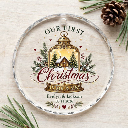 Round glass ornament with gold lantern, cozy cabin, pine branches, holly berries, and Our First Christmas as Mr & Mrs.