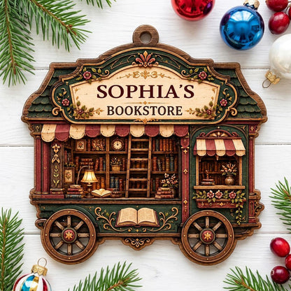 Custom-cut wood ornament shaped like a vintage bookstore wagon with books, ladder, and striped awnings.