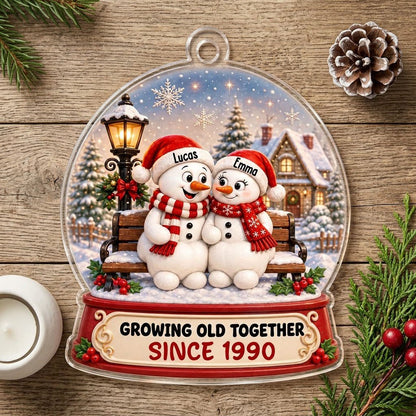 Acrylic snowglobe ornament with two snowmen on a bench, Santa hats, and Growing Old Together text.