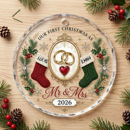 Round glass ornament with gold rings, red heart gem, red and green stockings, pine branches and Mr & Mrs text.