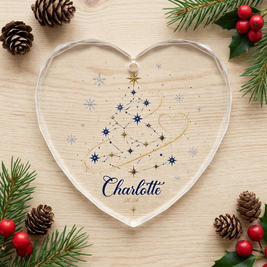 Heart-shaped stained glass suncatcher with a starry Christmas tree, gold ribbon heart, and snowflakes.