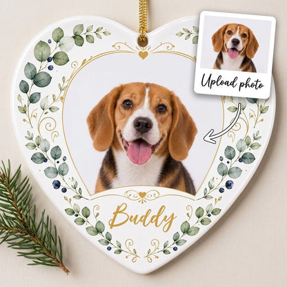 Heart ceramic ornament with a pet photo framed by gold heart scrollwork and eucalyptus with dark blue berries.