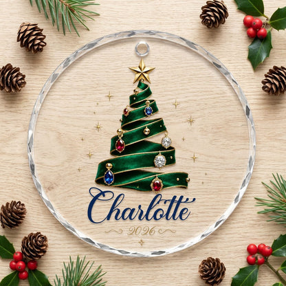 Round glass ornament with emerald ribbon tree, gold star and gem ornaments, personalized with name and year.
