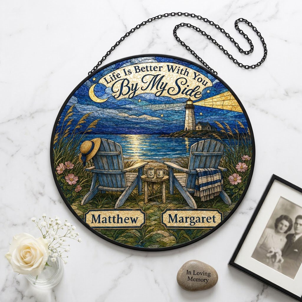 Round stained glass–style suncatcher with two blue Adirondack chairs by water and a lighthouse at night.