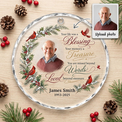 Round glass ornament with memorial quote, four red cardinals, pine and holly greenery, and a center photo portrait.