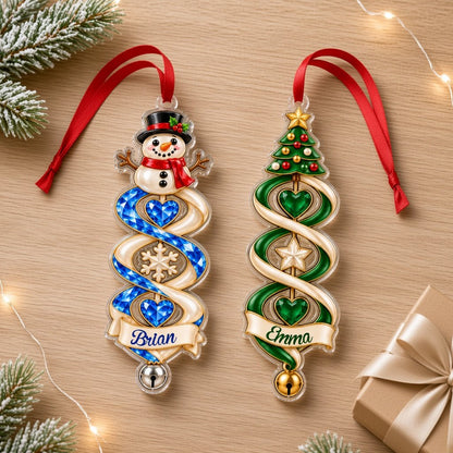 Custom-cut acrylic ornament with snowman or Christmas tree, spiral ribbon, gem hearts, and a name banner with bell.