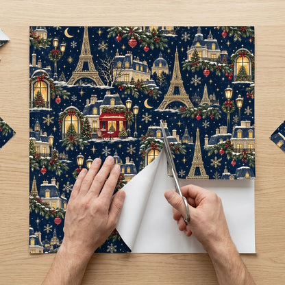 Navy Christmas wrapping paper with golden Eiffel Towers, Parisian buildings, a red cafe, stars, moons and snowflakes.