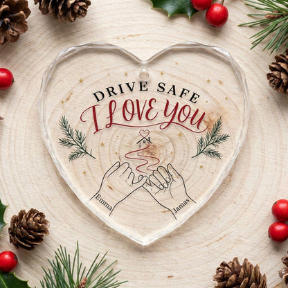 Heart glass ornament with pinky promise hands, red thread to a small house with heart, pine sprigs and gold stars.