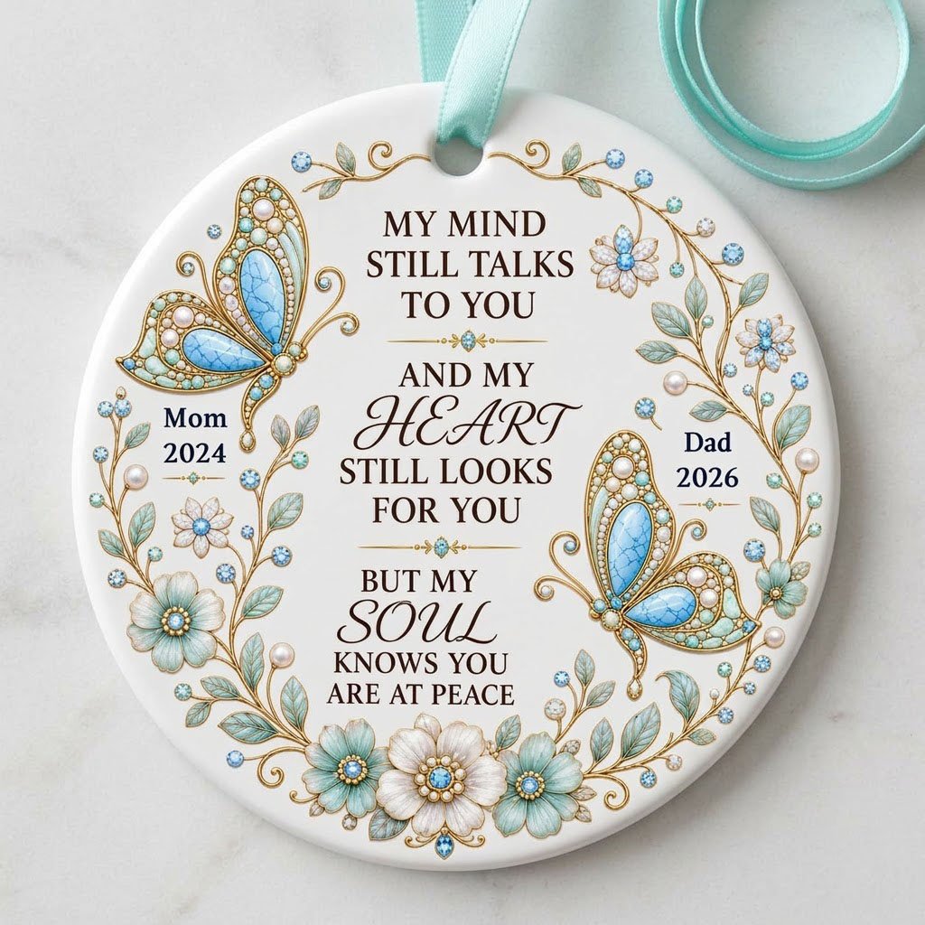 White round ornament with jeweled butterflies, floral wreath, and memorial quote with personalized name and year.