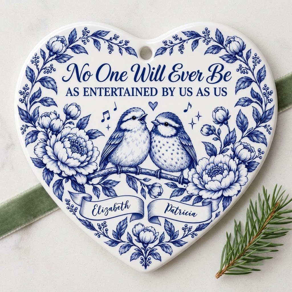 Heart ceramic ornament with two birds, blue floral frame, music notes above, and two name banners in cobalt.
