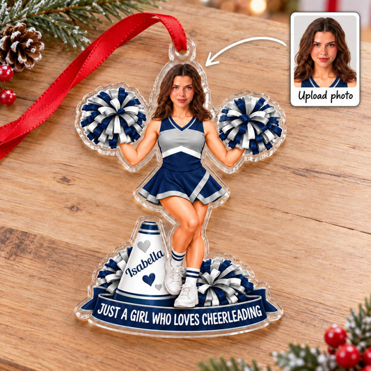 Custom acrylic cheerleader ornament with photo face, pom-poms, megaphone and name banner with red hanging ribbon.