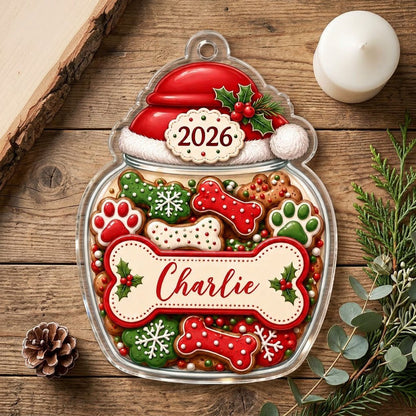 Custom-cut acrylic ornament shaped like a cookie jar with Santa hat, dog bone name plaque, and 2026 year badge.