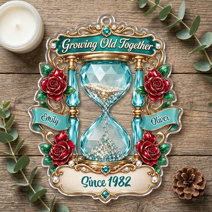 Custom-cut acrylic ornament with jeweled hourglass, red roses, and the words 'Growing Old Together'.
