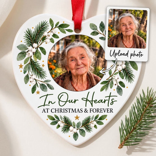 Heart ceramic ornament with In Our Hearts and AT CHRISTMAS & FOREVER around a circular photo frame with green foliage.