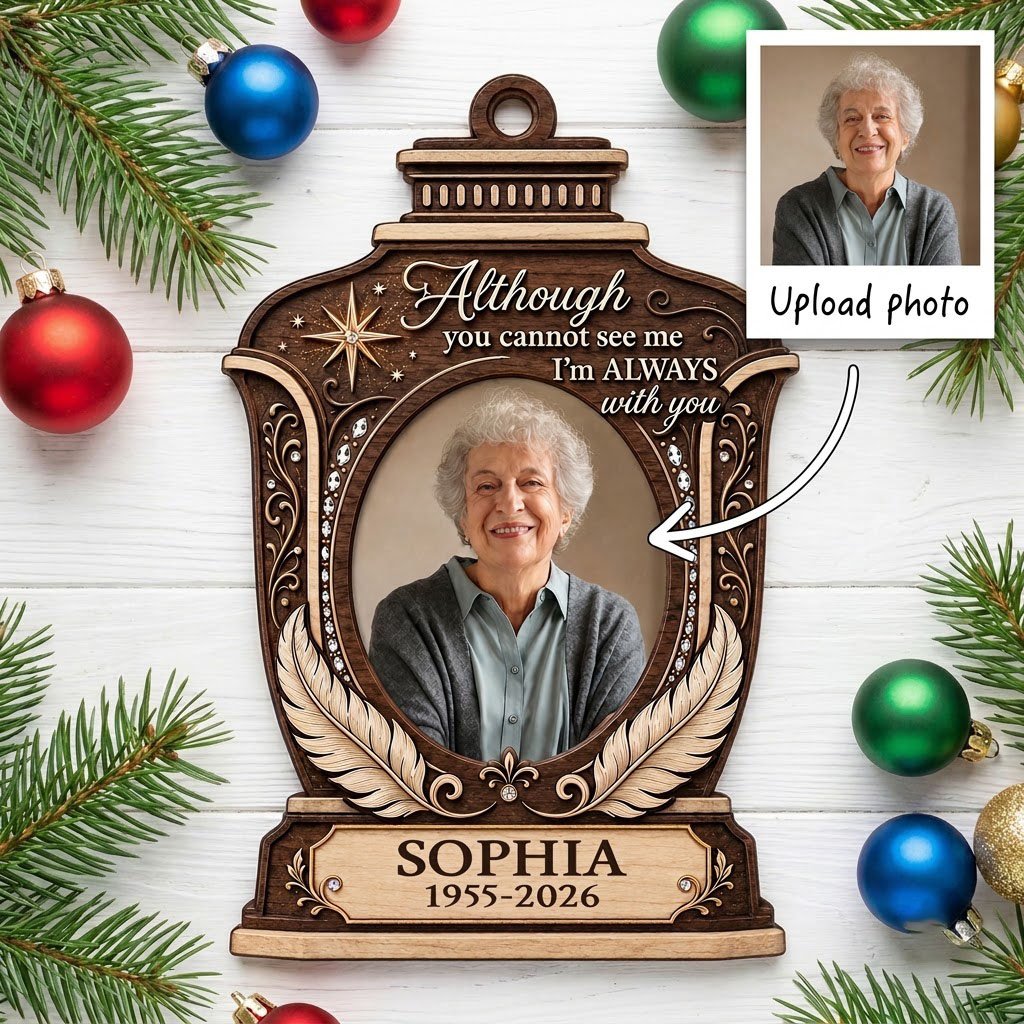 Lantern-shaped memorial wood ornament with oval photo, two feathers, starburst, fleur-de-lis and scrollwork accents.