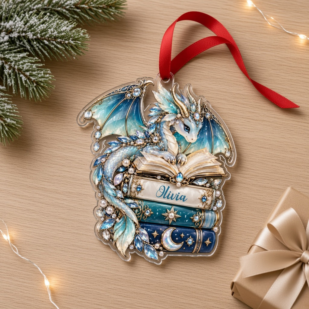 Custom-cut acrylic ornament of a jeweled blue dragon on stacked books with a red ribbon and a personalized name.