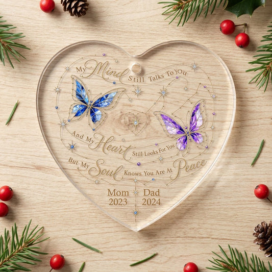 Heart-shaped glass ornament with blue and purple stained-glass butterflies, gold swirls, and memorial text.