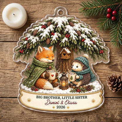 Acrylic ornament with snowy tree, fox and hedgehog holding mugs, banner says BIG BROTHER, LITTLE SISTER.
