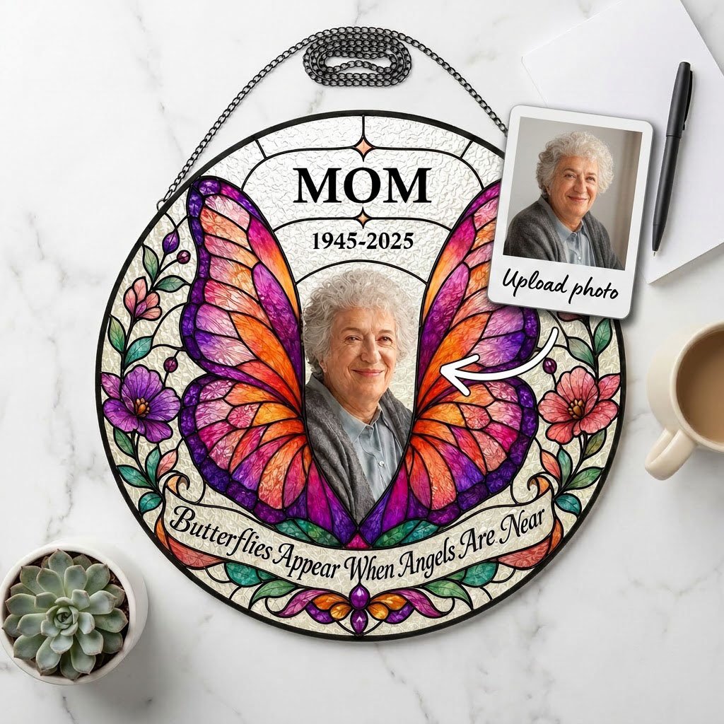 Round stained-glass suncatcher with butterfly wings, purple and pink flowers, a photo arch and a name banner.