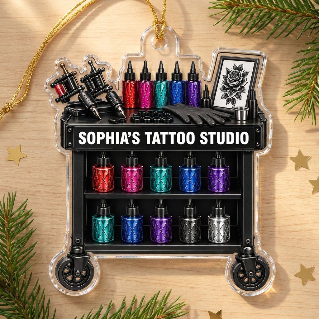 Acrylic ornament shaped like a tattoo cart with machines, colorful inks, and 'SOPHIA'S TATTOO STUDIO' text.