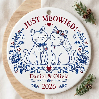 Round ceramic ornament with two wedding cats, 'JUST MEOWIED!', names and year with blue and red folk floral accents