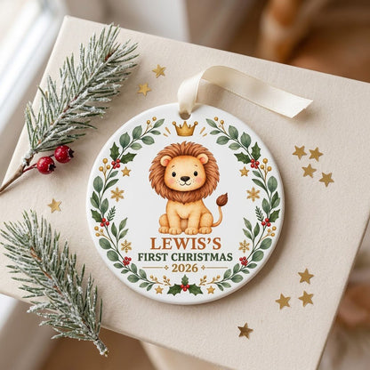 Round ceramic ornament with a cute crowned lion inside a festive wreath of green leaves, red berries, stars and snowflak