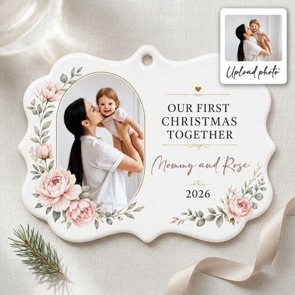 White scalloped ceramic ornament with gold oval photo frame, pink peonies, and Our First Christmas Together text.