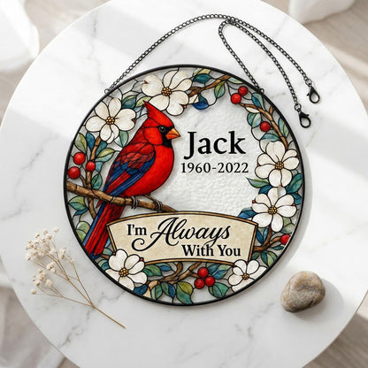 Round stained glass–style suncatcher with a red cardinal on a branch, white flowers, red berries, and a scroll banner.