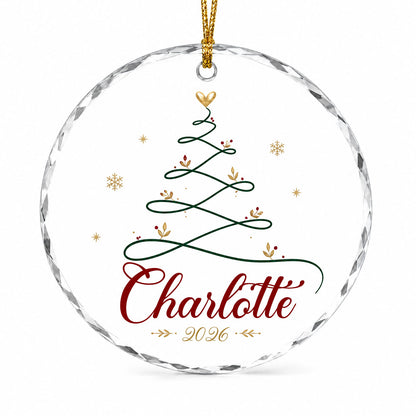 Clear round glass ornament with a looping green line Christmas tree topped by a small gold heart, name and year.