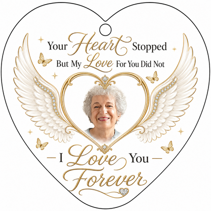 Heart-shaped glass ornament with white angel wings, gold heart photo frame, golden butterflies and sparkles.