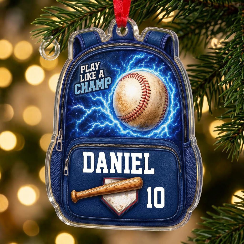 Backpack-shaped acrylic ornament with a baseball, blue lightning, a bat on home plate, and PLAY LIKE A CHAMP text.
