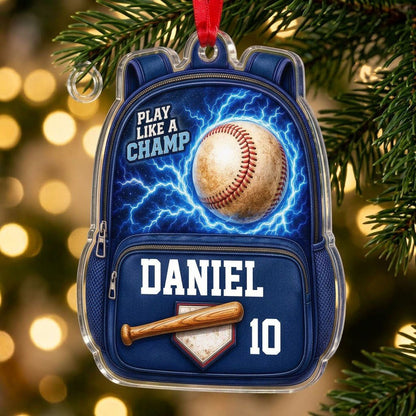 Backpack-shaped acrylic ornament with a baseball, blue lightning, a bat on home plate, and PLAY LIKE A CHAMP text.