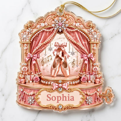 Pink ballet music box ornament with pointe shoes, velvet curtains, pearls, snowflakes, and a name plaque.