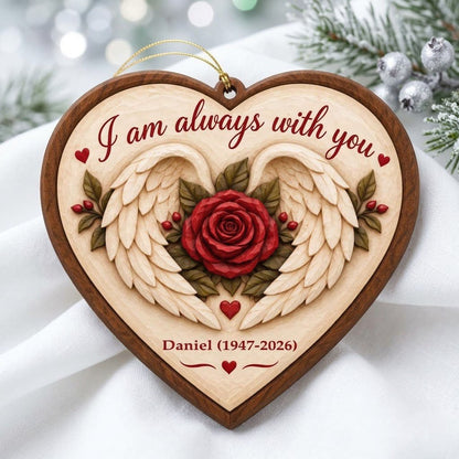 Heart-shaped wood ornament with angel wings around a red rose and the words 'I am always with you'.
