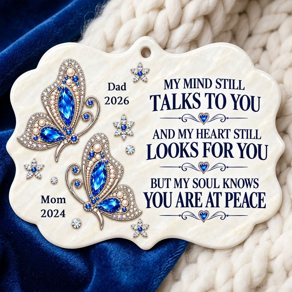 Scalloped ceramic ornament with two blue jeweled butterflies, silver starburst flowers and a memorial quote.