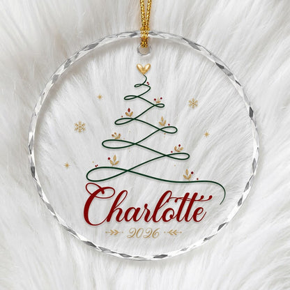 Clear round glass ornament with a looping green line Christmas tree topped by a small gold heart, name and year.