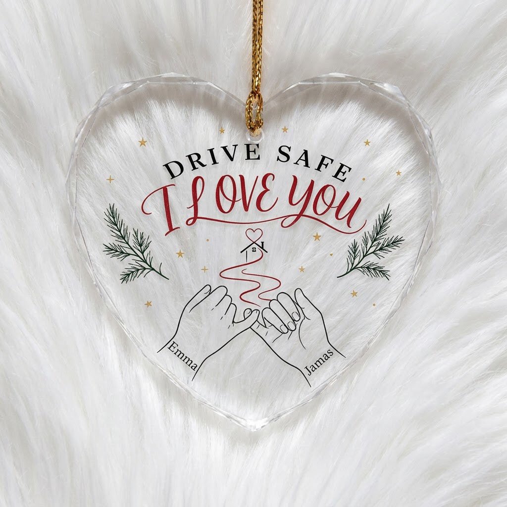 Heart glass ornament with pinky promise hands, red thread to a small house with heart, pine sprigs and gold stars.