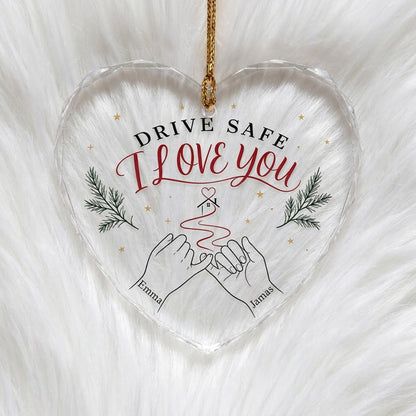 Heart glass ornament with pinky promise hands, red thread to a small house with heart, pine sprigs and gold stars.