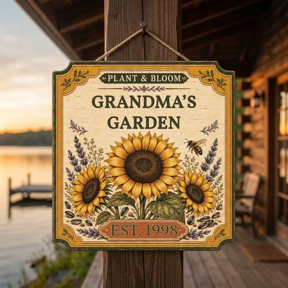 Square bracketed wooden sign with three sunflowers, lavender, a honeybee, and “Plant & Bloom” and “Grandma’s Garden” tex