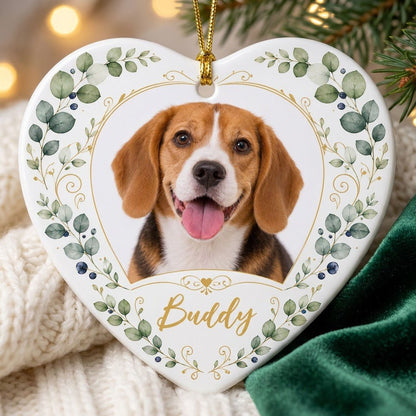 Heart ceramic ornament with a pet photo framed by gold heart scrollwork and eucalyptus with dark blue berries.