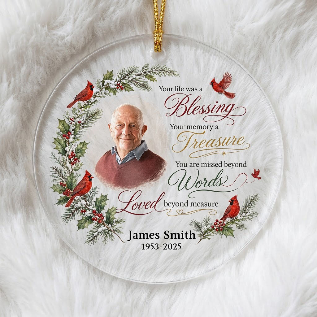 Round glass ornament with memorial quote, four red cardinals, pine and holly greenery, and a center photo portrait.