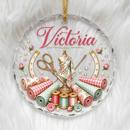 Round faceted glass ornament with a vintage dress form, sewing notions, and personalized name Victoria in pink and gold 