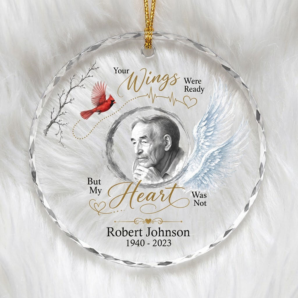 Round glass ornament with a sketch portrait frame, blue angel wing, red cardinal and 'Your Wings Were Ready' memorial te