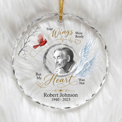 Round glass ornament with a sketch portrait frame, blue angel wing, red cardinal and 'Your Wings Were Ready' memorial te