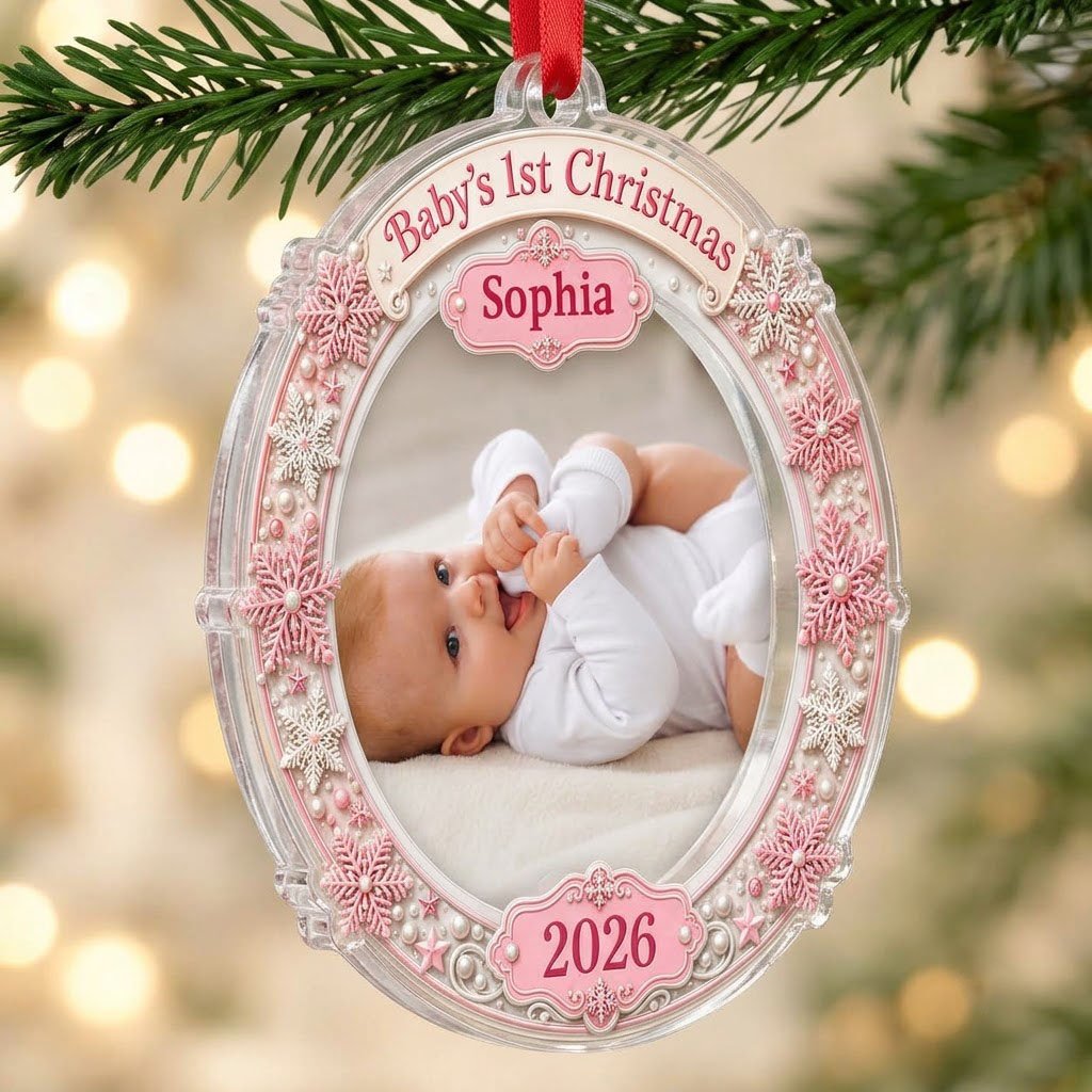 Round acrylic ornament with pink and white snowflakes framing a baby photo and the words Baby's 1st Christmas.