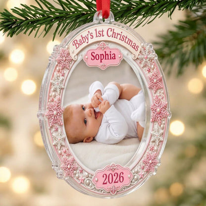 Round acrylic ornament with pink and white snowflakes framing a baby photo and the words Baby's 1st Christmas.