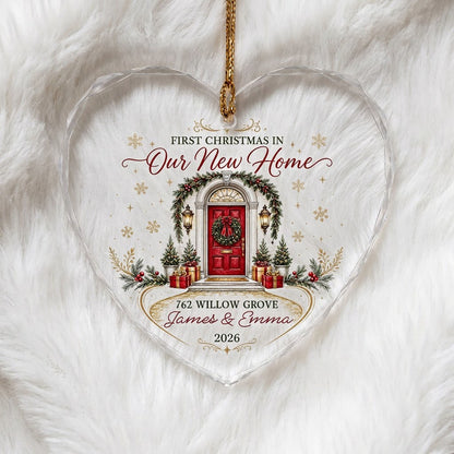 Heart-shaped glass ornament with a red front door, wreath, garland, lanterns, gift boxes, and gold snowflakes.